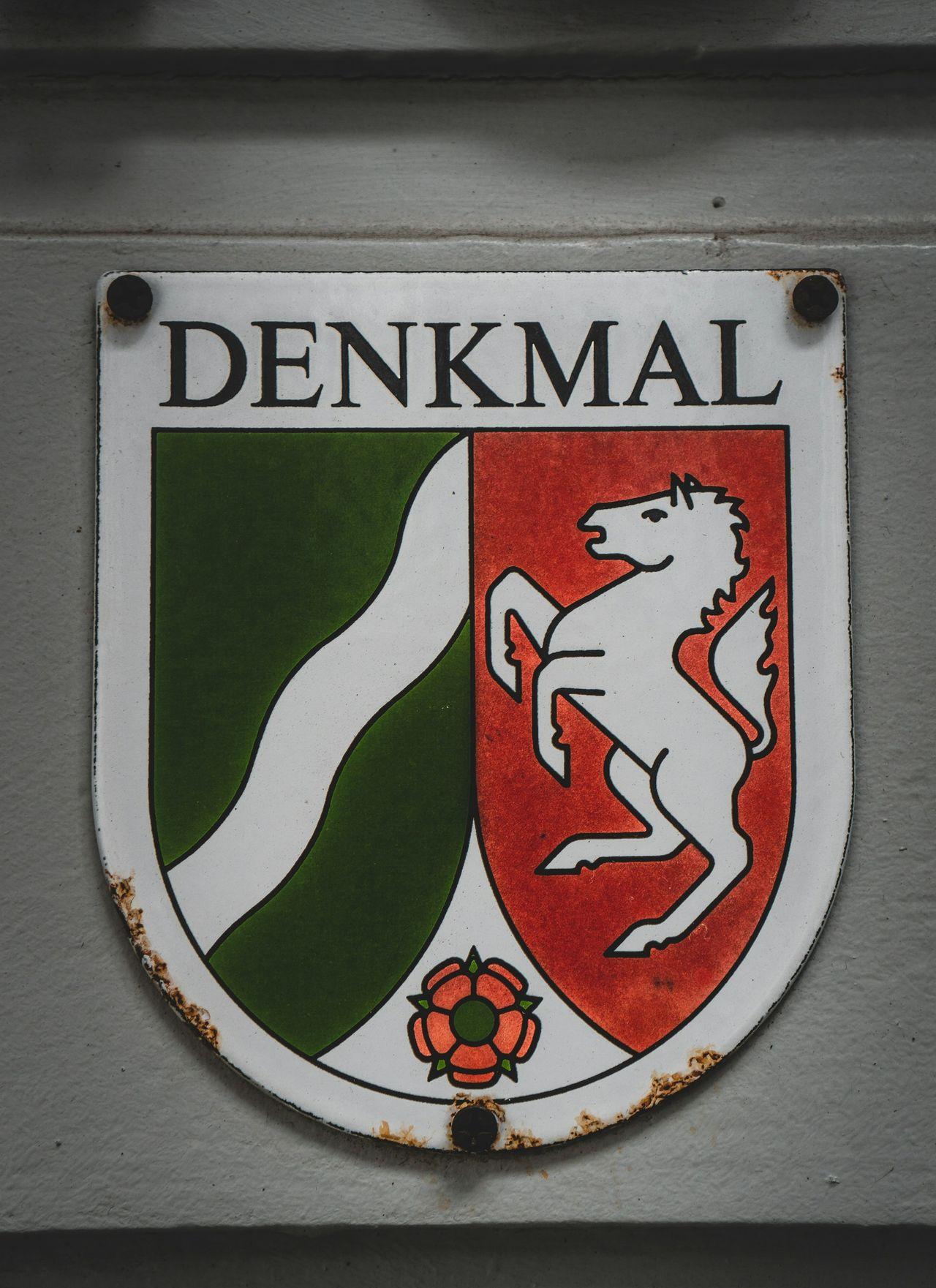a sign on the side of a building that says denkmal