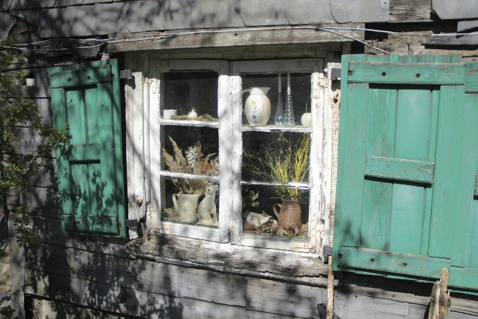 green wooden window with white wooden frame