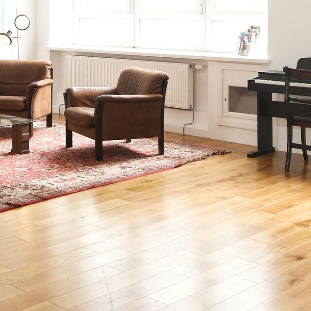 living room with brown wooden parquet floor and white wall